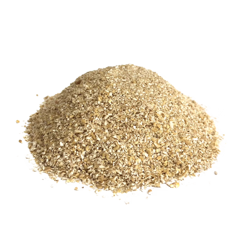 Pile of crushed oats on a white background with a small amount scattered around the base.